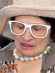 Older brunette seductively posing in leg stockings